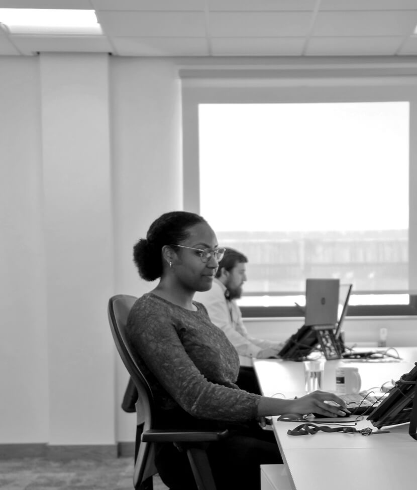 Woman sitting at desk using Concertus computer